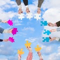 People hands with puzzle pieces with white clouds Royalty Free Stock Photo