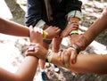 People, hands together and outdoor festival with arm bands for community, teamwork or unity at event. Group of friends Royalty Free Stock Photo