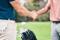 People, handshake and golf sport for partnership, trust or unity in community, collaboration or teamwork on grass field Royalty Free Stock Photo