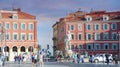 People hang around Massena Square in Nice Cote d'Azur during the sunset with orange sky, France.