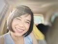 Selfies of girl smiling or Asian woman smiling in the car and looking at camera Royalty Free Stock Photo