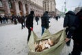 People harvest wood for fires on the frosty winter street in front of the city administration during anti-government protest