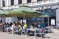 A people has lunch on the open veranda of a McDonalds cafe in Riga Old Town Royalty Free Stock Photo