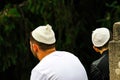 2 people, the Hasidim Jews in traditional bales sit in a park in Uman, the time of the Jewish New Year, Rosh-ha-Shana