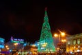 People have fun in Christmas time passing the famous illuminated christmas tree at puerta del sol in Madrid, Spain