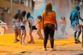 People have fun with paint powder during a colorful race at Dique do Tororo in the city of Salvador, Bahia