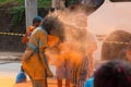 People have fun with paint powder during a colorful race at Dique do Tororo in the city of Salvador, Bahia