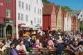 People have lunch at street restaurants at Bruggen in Bergen, Norway. Royalty Free Stock Photo