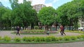 People have a rest in city park with tulips