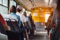 People have a ride in public transport from the work at sunset time