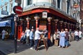 People having a drink outside English bar in the Soho, London UK