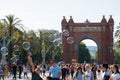 People Having Fun And Making Soap Bubbles For Children Near The Arc de Triomf Triumphal Arc Or Arco de Triunfo