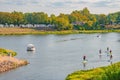 People having fun at old Elbe river in the historical downtown of Magdeburg, Germany, early Autumn