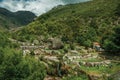 People having fun in public fluvial pool amid hilly landscape