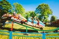 People Having Fun On Rollercoaster In The Park