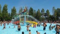 People having fun in the swimming pool in water park