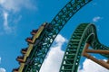 People having fun terrific Cheetah Hunt rollercoaster on lightblue cloudy sky background 52 Royalty Free Stock Photo