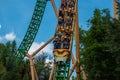 People having fun terrific Cheetah Hunt rollercoaster on lightblue cloudy sky background 51 Royalty Free Stock Photo