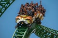 People having fun terrific Cheetah Hunt rollercoaster on lightblue cloudy sky background 73 Royalty Free Stock Photo