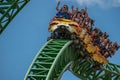 People having fun terrific Cheetah Hunt rollercoaster on lightblue cloudy sky background 74 Royalty Free Stock Photo