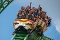 People having fun terrific Cheetah Hunt rollercoaster on lightblue cloudy sky background 78. Royalty Free Stock Photo