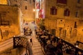 People having late dinner in restaurant on small stone bridge of historical city