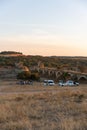 People having a picnic in Alentejo landscape with abandoned destroyed Ajuda bridge on the background at sunset, in Portugal
