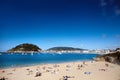 People having a rest on a sandy beach. Seaside resort. Summer sunny day. San Sebastian Donostia, Basque country, Spain Royalty Free Stock Photo