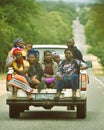 People heading home in back of truck