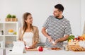 Happy couple cooking food at home kitchen Royalty Free Stock Photo