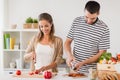 Happy couple cooking food at home kitchen Royalty Free Stock Photo