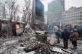 People heating by the fire near the barricades after fights with police on the broken street of Kiev during anti-government riot