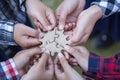 People helping in assembling puzzle, cooperation in decision making, team support in solving problems and corporate group teamwork Royalty Free Stock Photo