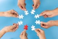 People helping in assembling puzzle, cooperation in decision making, team support in solving problems and corporate group teamwork Royalty Free Stock Photo