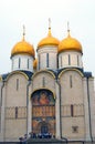 People hide from the rain under Dormition church walls.