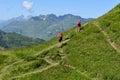 People hiking in the mountain path at Jochpass over Engelberg on the Swiss alps Royalty Free Stock Photo