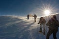 People hiking on the snow in a wind storm