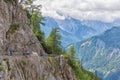 People at hiking trail through Austrian mountains to ice cave Royalty Free Stock Photo