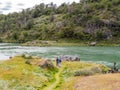 People hiking on trail of Paseo de la isla, along Lapataia River