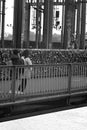 People in Hohenzollern bridge in front of the railing with love locks in Cologne, Germany