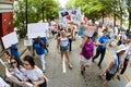 People Hold Banners And Signs Walking In Immigration Law Protest