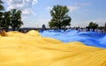 People hold biggest flag of Ukraine. Huge yellow and blue Ukrainian national state flag, in city Dnipro. Symbol of patriotism and