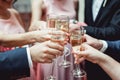 People hold in hands glasses with white wine. wedding party. Royalty Free Stock Photo