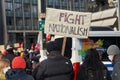 People hold up a sign with the text `Fight Nationalism`