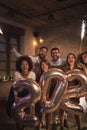 People holding 2020 balloons and sparklers at New Years party Royalty Free Stock Photo