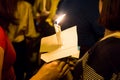 People holding candle vigil in darkness seeking hope, worship, p Royalty Free Stock Photo