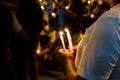 People holding candle vigil in darkness seeking hope, worship, p Royalty Free Stock Photo