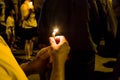 People holding candle vigil in darkness seeking hope, worship, p Royalty Free Stock Photo