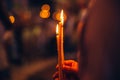 People holding candles in a church. Bokeh candle lights in the background. Royalty Free Stock Photo