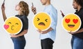 People holding emoticons and mobile devices